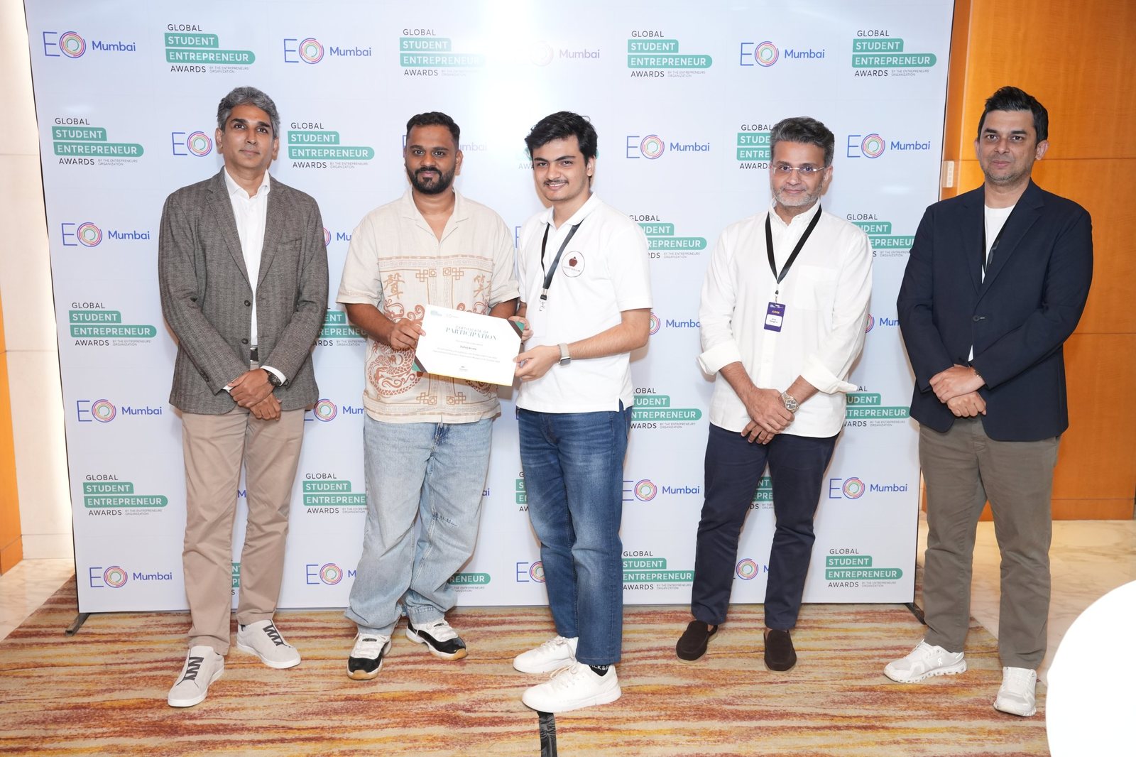 Sahej holding his certificate with the EO GSEA panel
