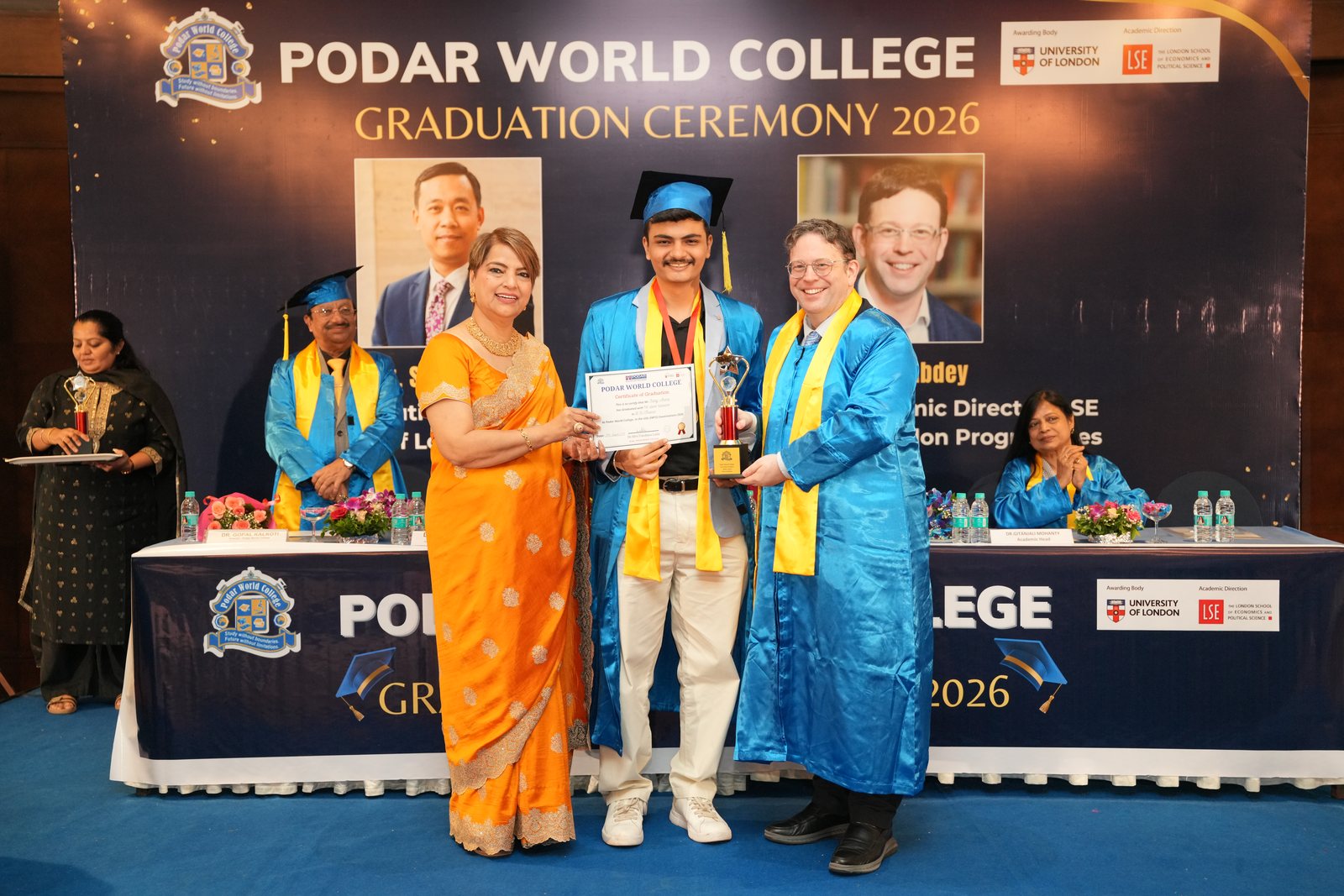 Sahej receiving his graduation certificate and an award on stage